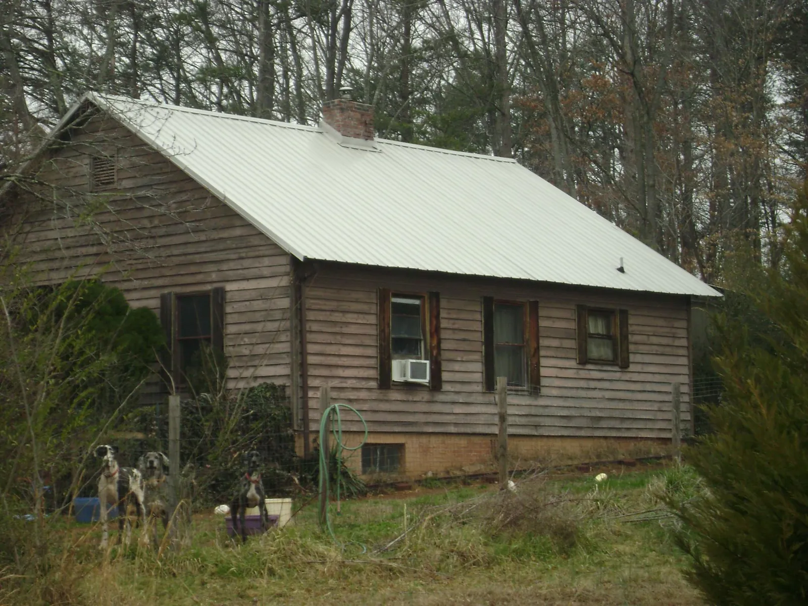 White metal roof on an old wood sided farmhouse, from a Metal Roof Installation job in Sturbridge